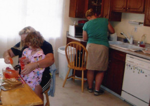 My daughter is making a potion with her grandma while I cook dinner in front of the windows that spooked my little girl.